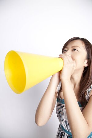 Woman with a megaphone shoutingの写真素材