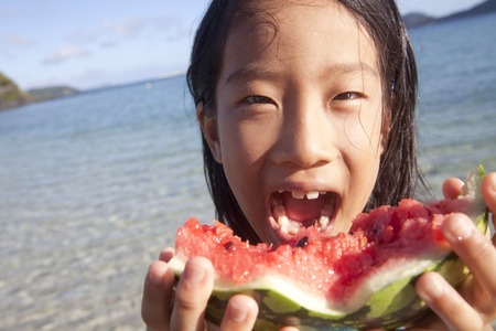 Girl eating watermelonの写真素材