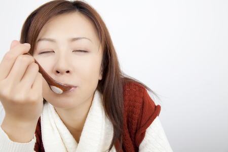 Women who drink the soup with a spoonの写真素材