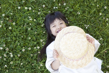 Girl lie down on grasslandの写真素材