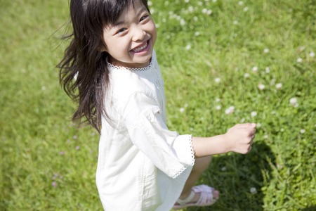 Girl smile that runs a grasslandの写真素材
