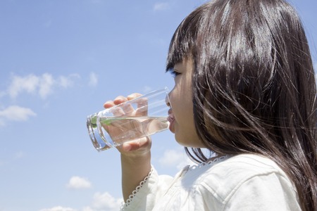 Girl drinking a glass of waterの写真素材