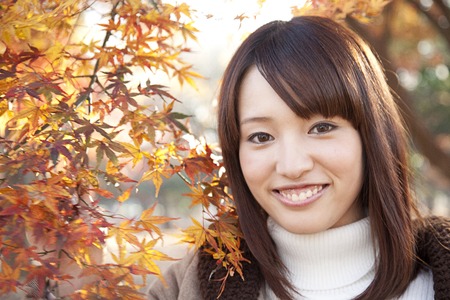 Woman smile touching the mapleの写真素材