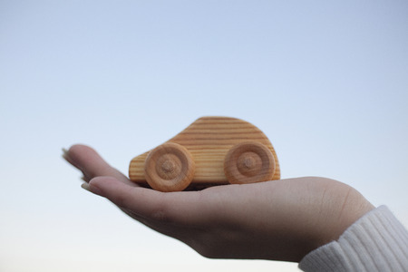 The hands of the women with the car of wooden toysの写真素材