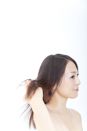 Woman combing the hair in Tekushiの写真素材