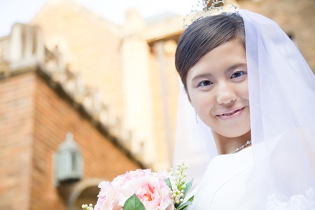 Bride standing in front of the Houseの写真素材