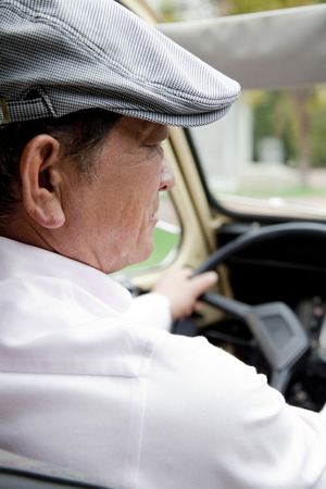 Senior man driving a carの写真素材