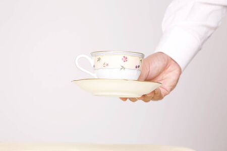 Cafe clerk to put the tea on the table