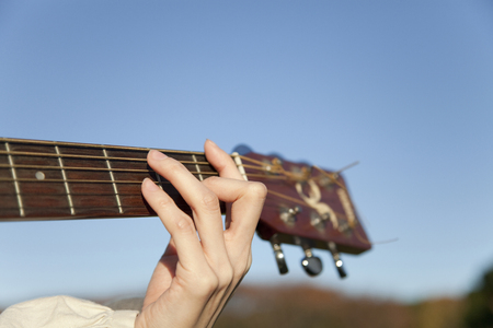 Hand of the woman playing the guitarの写真素材