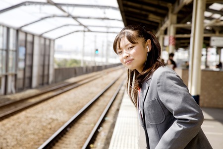 Schoolgirl waiting for a trainの写真素材