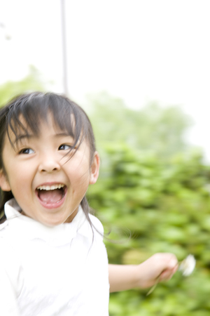 Girls run around with a smileの写真素材