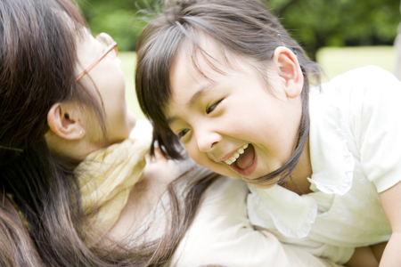 Girl play with her motherの写真素材