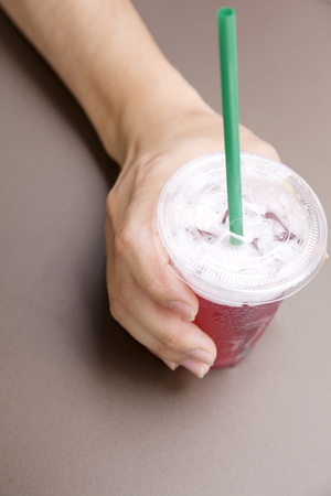 Hand that tries to take a juice cupの写真素材