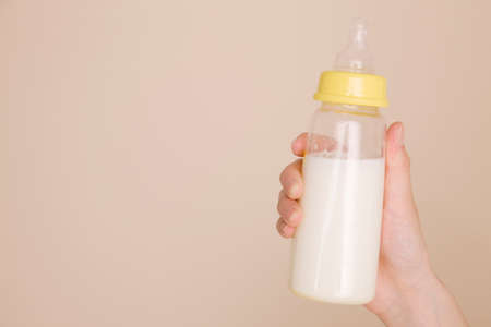 The hands of mothers with containing milk bottleの写真素材