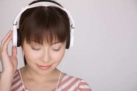 Women who are relax and listen to music with headphonesの写真素材