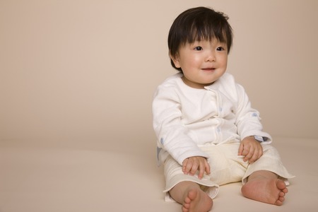 Baby is laughing while sittingの写真素材