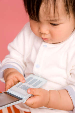 Baby with a mobile phoneの写真素材