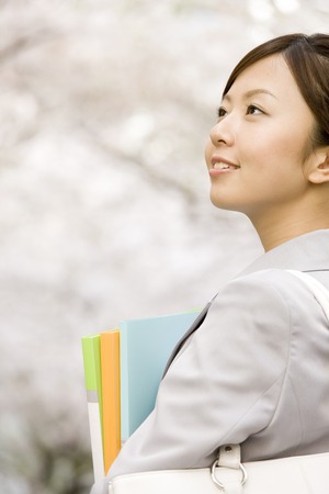 OL look up at the cherryの写真素材