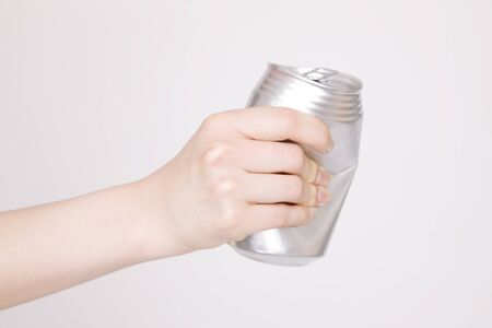 Hand of woman crush empty cans