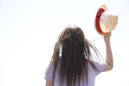 Back view of women who are taking the hatの写真素材