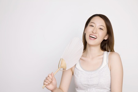 Woman with a fanの写真素材