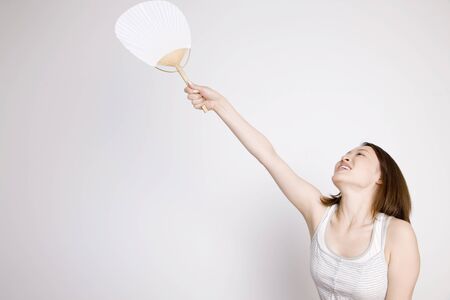 Woman with a fanの写真素材