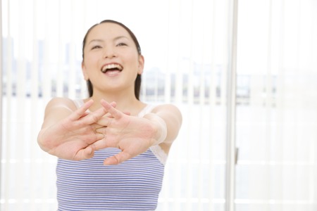 Woman stretching in bedroomの写真素材