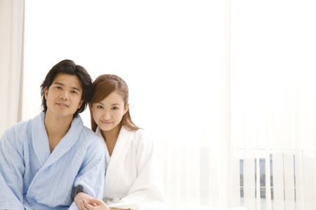 Men and women nestling wearing a bathrobeの写真素材