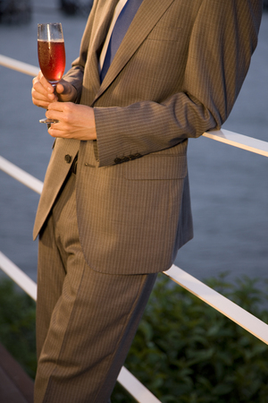 Hand of man with a rose wineの写真素材