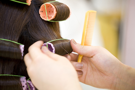 Hand of the hairdresser to apply a perm women's hairの写真素材