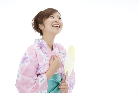Yukata women flexing in the fanの写真素材
