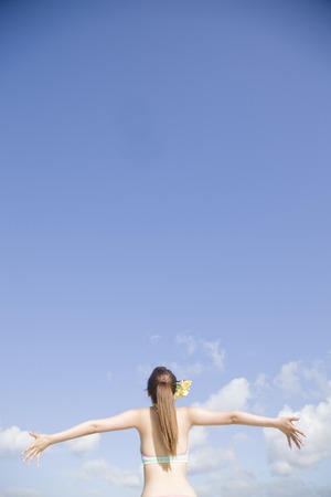 Women Rear View of swimsuit spread your hands are feeling the windの写真素材