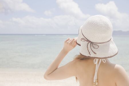 Back view of woman overlooking the seaの写真素材
