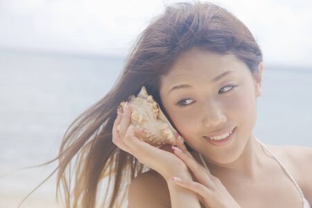 Women shed ear to shellfishの写真素材