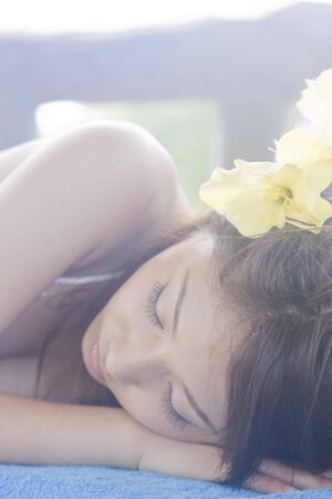 Women lie down on a benchの写真素材