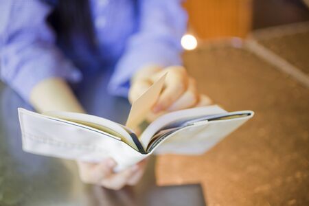 Woman holding a bookの写真素材