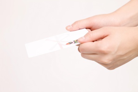 Hand of the woman with a Red Pocketsの写真素材