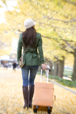 Back shot of a woman with a carry bagの写真素材