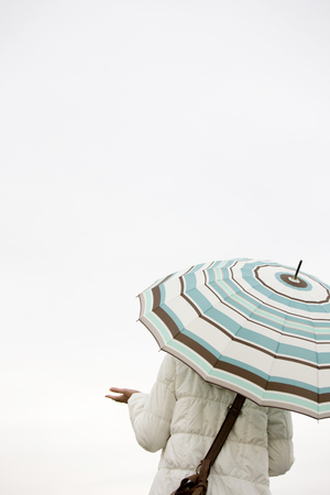 Back shot of a woman stabbed umbrellaの写真素材