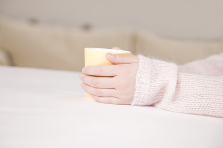 Hand of woman with a cupの写真素材