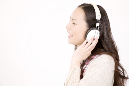 Woman listening to music with headphonesの写真素材