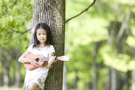 Girl playing the ukuleleの写真素材