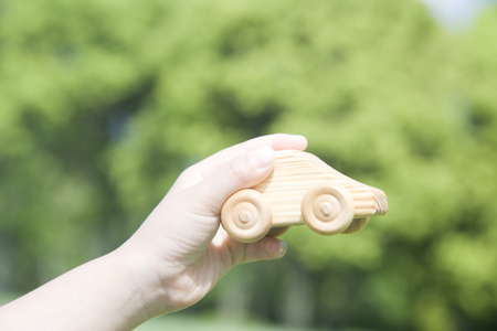 Hand of the girl playing in the car of the treeの写真素材