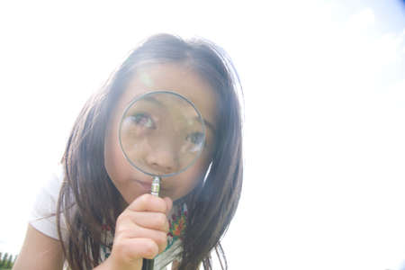 Girl that use the magnifying glassの写真素材