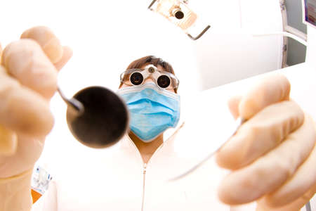 Dental hygienist looking into the patientの写真素材