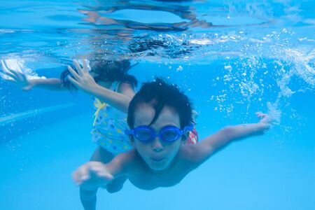 Boy swimsuit swim underwaterの写真素材