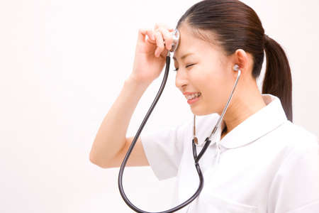 Nurse shed stethoscope to my foreheadの写真素材
