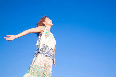 Women who spread his hands on top of the hillの写真素材