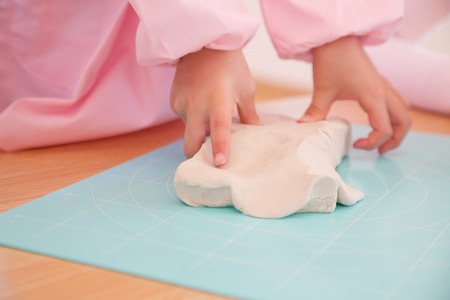 Hand of kindergarten girls play with clayの写真素材