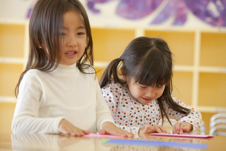 Folding origami nursery girlsの写真素材